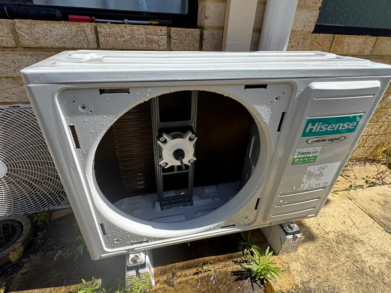 Outdoor aircon unit after cleaning, with its base and casing rinsed