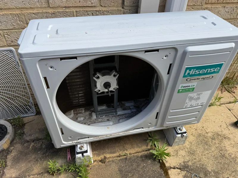 Outdoor aircon unit with dirt and debris before cleaning